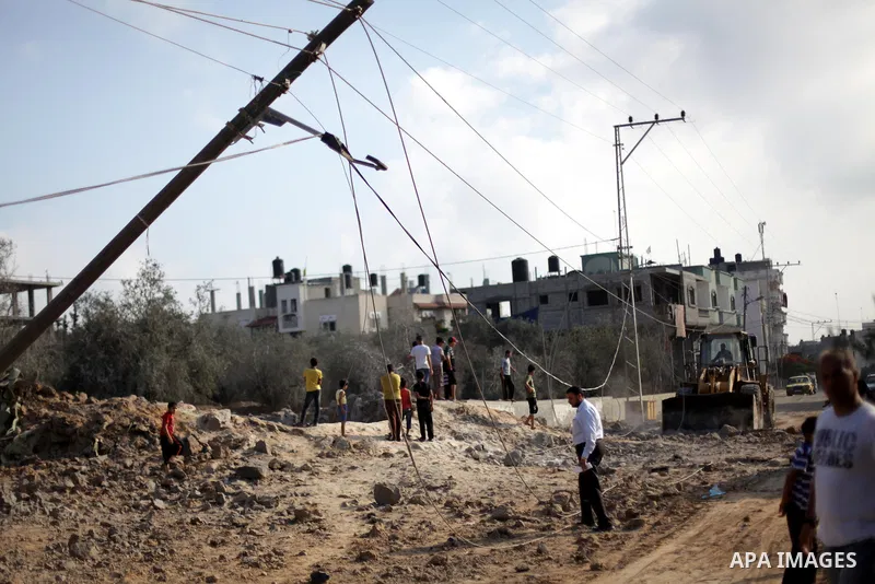 Palestinians survey a site which witnesses said was destroyed in an Israeli air strike in the central Gaza Strip June 24, 2013. Israel carried out air strikes in the Gaza Strip on Monday in response to Palestinian milita...