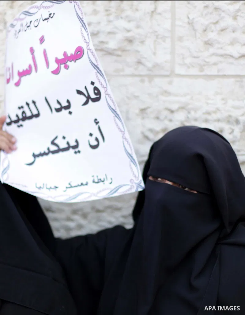 Palestinians hold pictures of prisoners held in Israeli jails during a protest outside Red Cross office in Gaza City, on June 24, 2013 in solidarity with Palestinian prisoners held by Israel to demand their release. Phot...