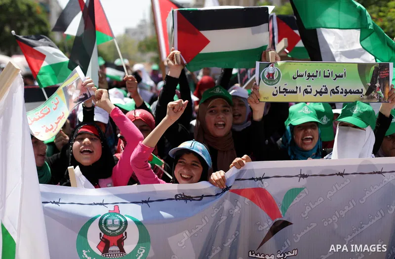 Palestinians hold pictures of prisoners held in Israeli jails during a protest outside Red Cross office in Gaza City, on June 24, 2013 in solidarity with Palestinian prisoners held by Israel to demand their release. Phot...
