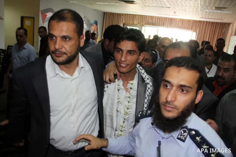 Arab Idol winner Palestinian Mohammed Assaf (C) arrives at Rafah crossing point on the border between Egypt and southern Gaza Strip, on June 25, 2013. Thousands of Gazans welcomed the arrival of Mohammad Assaf, the 23-ye...