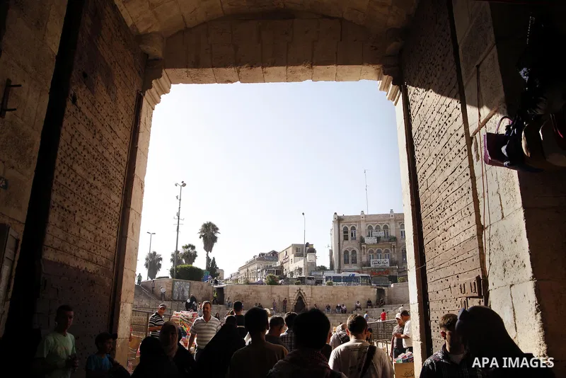 Palestinians walk out at Damascus gate near al-Aqsa mosque in Jerusalem's Old City, June 26, 2013. Photo by Saeed Qaq
