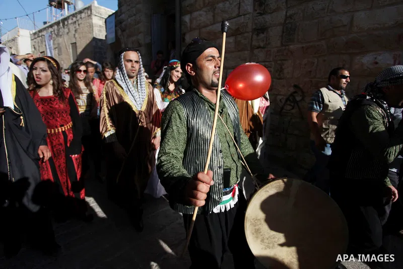 Palestinians take a part in a traditional wedding in the West Bank Town of Birzeit, near Ramallah during the Rozana Cultural Festival, June 26, 2013. Photo by Issam Rimawi