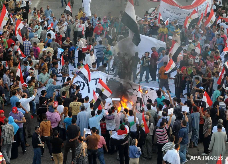 Egyptian protesters burn an Israeli flah during a demonstration againt President Mohammed Morsi in front of Ministry of Defense, in Cairo, Egypt, Friday, June 28, 2013. Elsewhere, thousands of supporters of Egypt's embat...