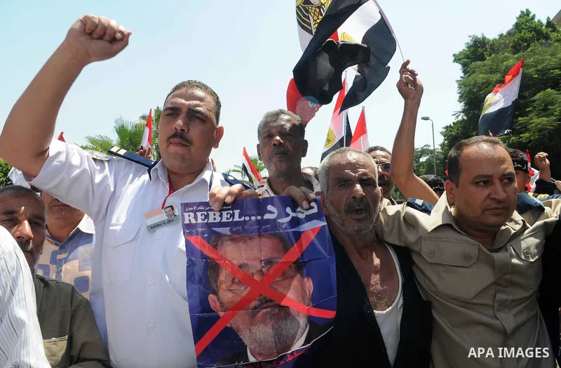 Egyptian protesters shout anti-President Mohammed Morsi slogans during a protest in front of Ministry of Defense, in Cairo, Egypt, Friday, June 28, 2013. Elsewhere, thousands of supporters of Egypt's embattled president...