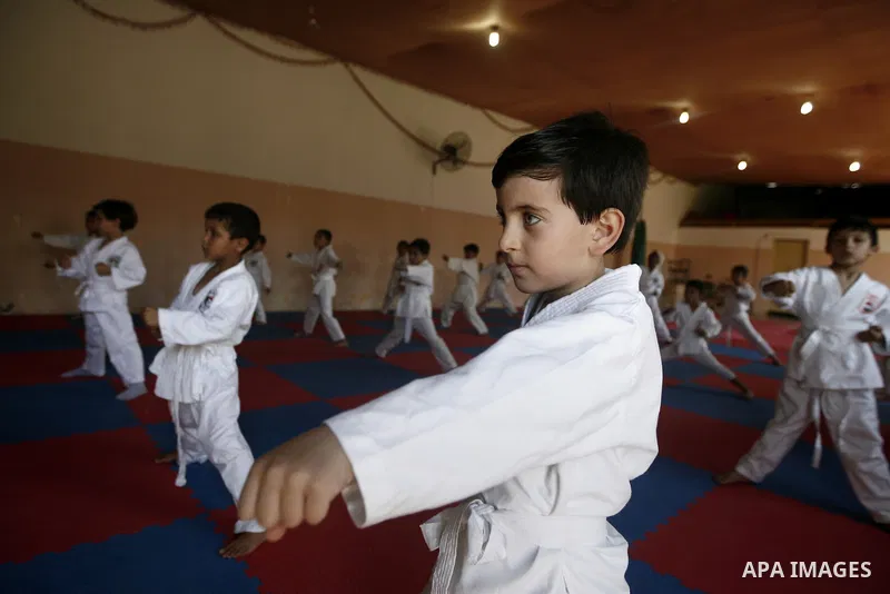 Palestinian boys take part in a karate class, which aims at teaching self-defense techniques during the summer holidays, at sport club in Gaza City on June 29, 2013. Photo by Emad Nassar