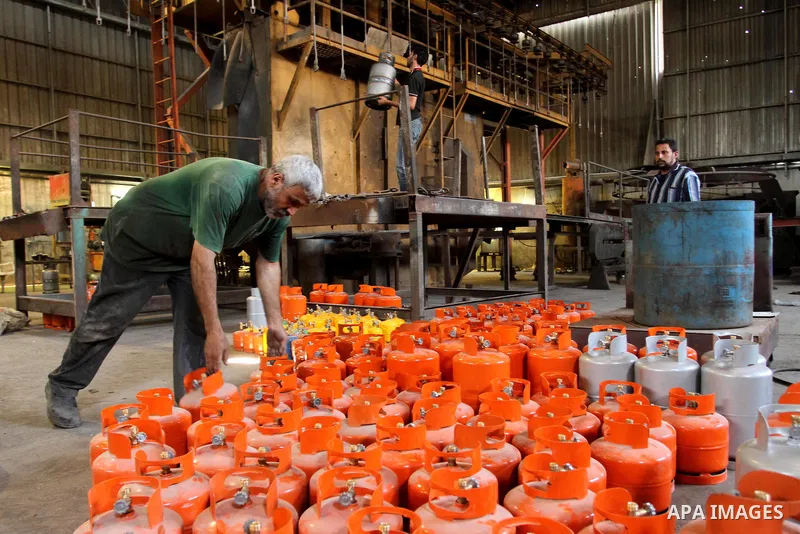 A Palestinian worker carries an empty cylinder at gas cylinders' factory in Gaza city on June 30, 2013. Egypt has intensified a crackdown on smuggling tunnels between its volatile Sinai desert and the Gaza Strip, causing...