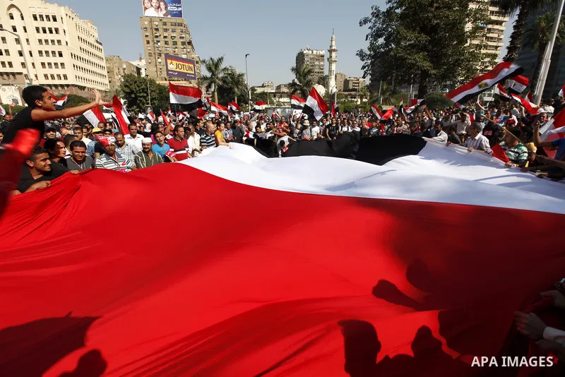 Protesters opposing Egyptian President Mohamed Mursi carry a huge flag as they march to Tahrir square from Mustafa Mahmoud mosque in Cairo June 30, 2013. Mass demonstrations across Egypt on Sunday may determine its futur...
