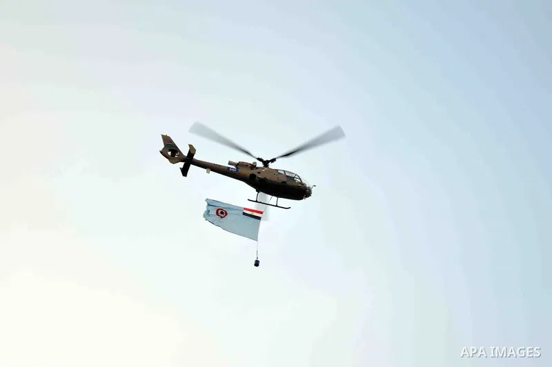 An Egyptian military helicopter flies over Tahrir square as opponents take part in a protest demanding that Egyptian President Mohamed Mursi resign, in Cairo July 1, 2013. Egypt's military on Monday issued a 48-hour ulti...