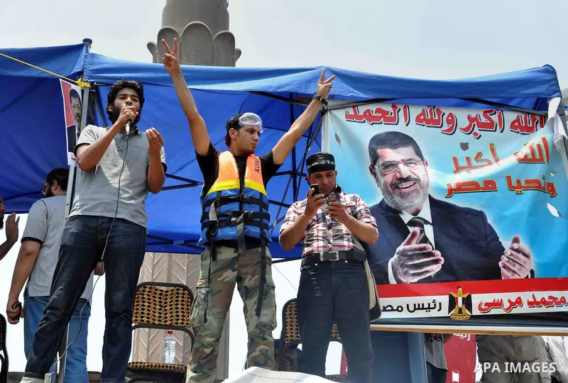 Supporters of Egyptian President Mohamed Mursi shout slogans during a protest to show support to him in front of Cairo University in Cairo July 3, 2013. At least 16 people were killed on Wednesday and 200 wounded when gu...