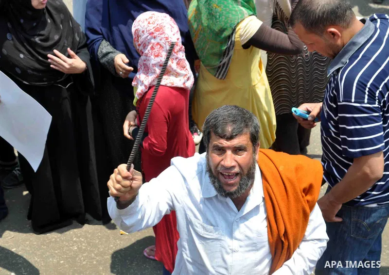 Supporters of Egyptian President Mohamed Mursi shout slogans during a protest to show support to him in front of Cairo University in Cairo July 3, 2013. At least 16 people were killed on Wednesday and 200 wounded when gu...