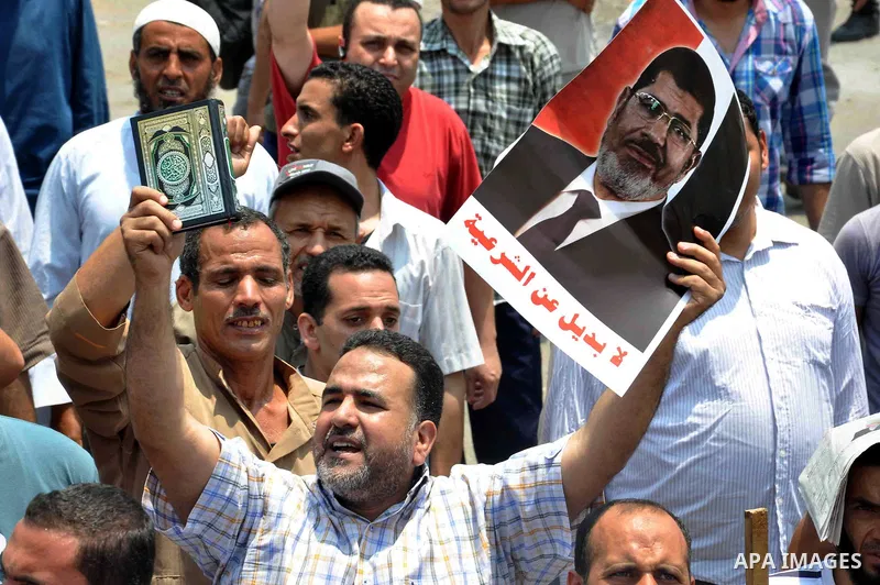 Supporters of Egyptian President Mohamed Mursi shout slogans during a protest to show support to him in front of Cairo University in Cairo July 3, 2013. At least 16 people were killed on Wednesday and 200 wounded when gu...