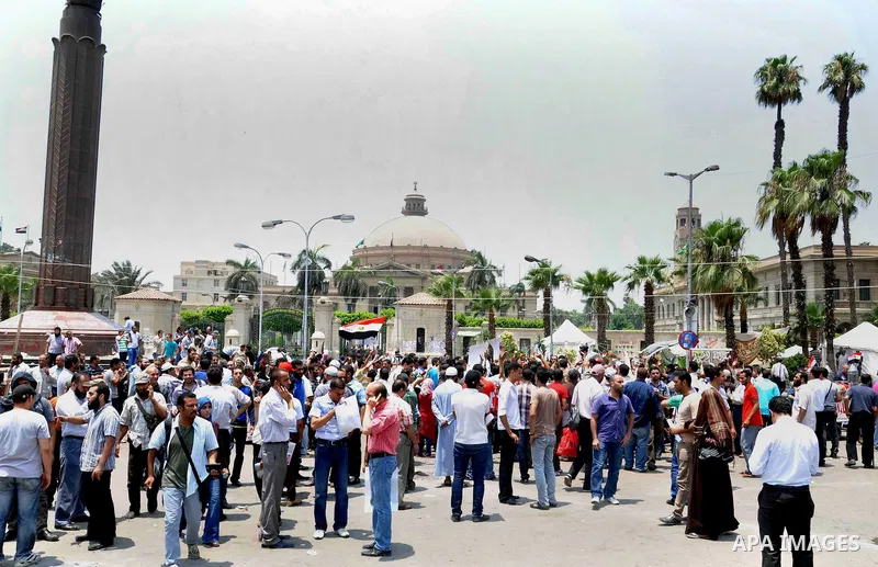 Supporters of Egyptian President Mohamed Mursi shout slogans during a protest to show support to him in front of Cairo University in Cairo July 3, 2013. At least 16 people were killed on Wednesday and 200 wounded when gu...