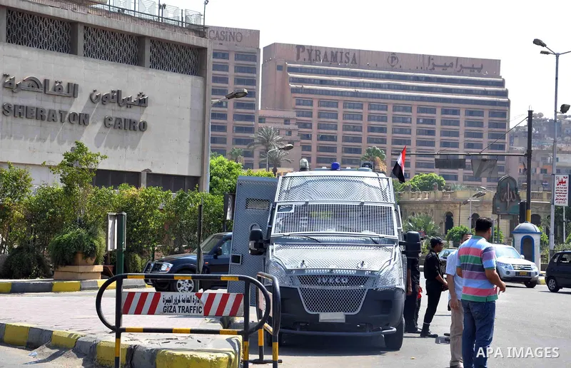 Egyptian police special forces stand next to their armored vehicle, protecting a bridge between Tahrir Square and Cairo University, where Muslim Brotherhood supporters have gathered, in Giza, Egypt, Wednesday, July 3, 20...