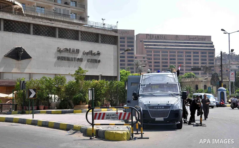 Egyptian police special forces stand next to their armored vehicle, protecting a bridge between Tahrir Square and Cairo University, where Muslim Brotherhood supporters have gathered, in Giza, Egypt, Wednesday, July 3, 20...