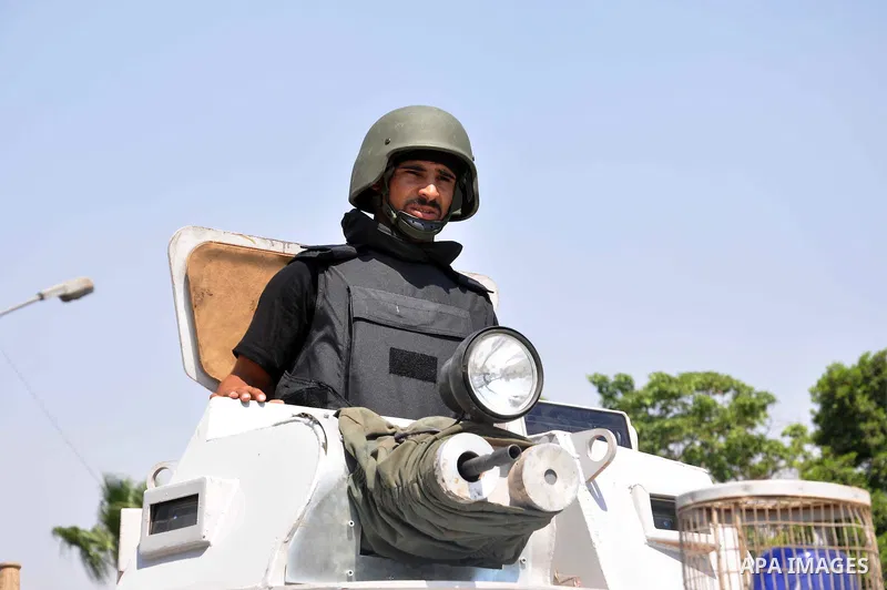 Egyptian police special forces sit on their armored vehicle, protecting a bridge between Tahrir Square and Cairo University, where Muslim Brotherhood supporters have gathered, in Giza, Egypt, Wednesday, July 3, 2013. Egy...