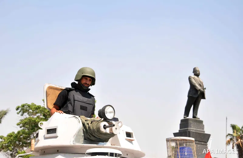 Egyptian police special forces sit on their armored vehicle, protecting a bridge between Tahrir Square and Cairo University, where Muslim Brotherhood supporters have gathered, in Giza, Egypt, Wednesday, July 3, 2013. Egy...