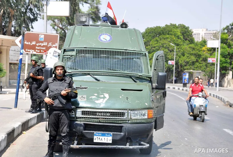 Egyptian police special forces stand next to their armored vehicle, protecting a bridge between Tahrir Square and Cairo University, where Muslim Brotherhood supporters have gathered, in Giza, Egypt, Wednesday, July 3, 20...