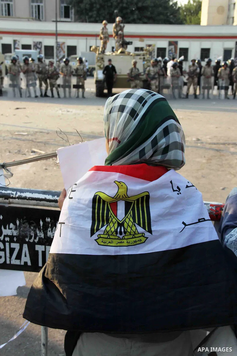 Egyptian supporters of Muslim Brotherhood hold portraits of ousted Egyptian president Mohammed Morsi as they gather at al-Nahda square on July 4, 2013 in Cairo, Egypt. Egypt's army rounded up the leadership of ousted pre...