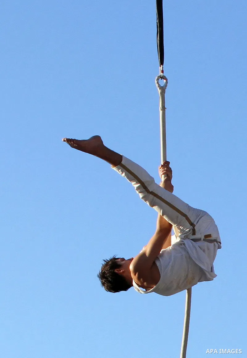 A member of Nablus circus school performs in the West Bank city of Nablus, July 04, 2013. Assirk Assaghir or 'Small Circus' is made up of a small group of motivated trainers, a larger group of enthusiastic students and o...