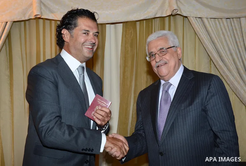 Palestinian President Mahmoud Abbas gives the diplomatic Palestinian passport to the Lebanese singer Ragheb Allama, in Beirut, Lebanon July 04, 2013. Abbas arrived in Beirut on 03 July for a three-day official visit to m...