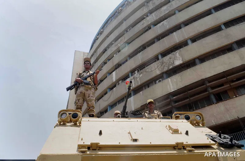 Egyptian military soldiers stand guard atop armored personnel carriers at Maspero, an Egypt's state tv and radio station, not far from Tahrir Square in Cairo Saturday, July 6, 2013. Egyptians were on edge Saturday mornin...