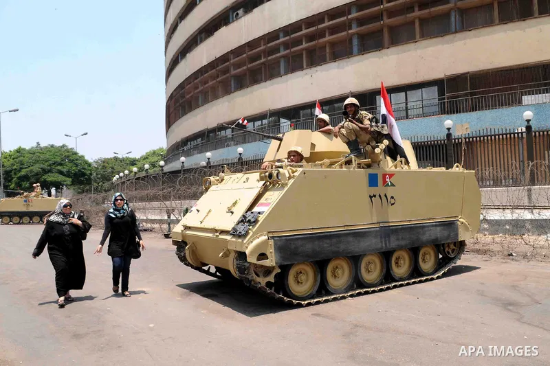 Egyptian military soldiers stand guard atop armored personnel carriers at Maspero, an Egypt's state tv and radio station, not far from Tahrir Square in Cairo Saturday, July 6, 2013. Egyptians were on edge Saturday mornin...