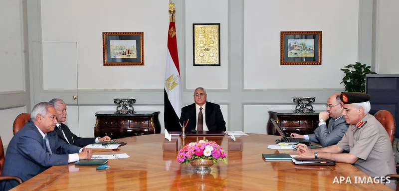 A handout picture released by the Egyptian Presidency shows Egypt's interim president Adly Mansour (C) meeting with opposition National Salvation Front leader Mohamed El Baradei (5thL) and heads of opposition Tamarod (Re...