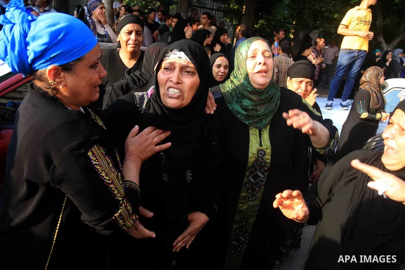 Relatives and protesters, who are against former Egyptian President Mohamed Mursi, react as coffins of men, who were killed during clashes with supporters of Mursi and Muslim Brotherhood members yesterday night in El-Man...