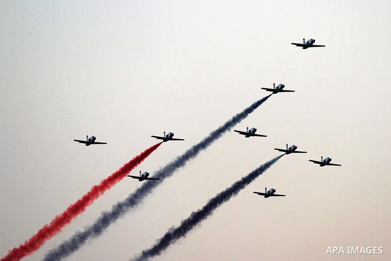 Egyptian jet fighters trail smoke in the colours of the national flag as they fly over Tahrir Square in Cairo, on July 7, 2013, as tens of thousands of people staged a show of force in Tahrir Square to back the army's ou...
