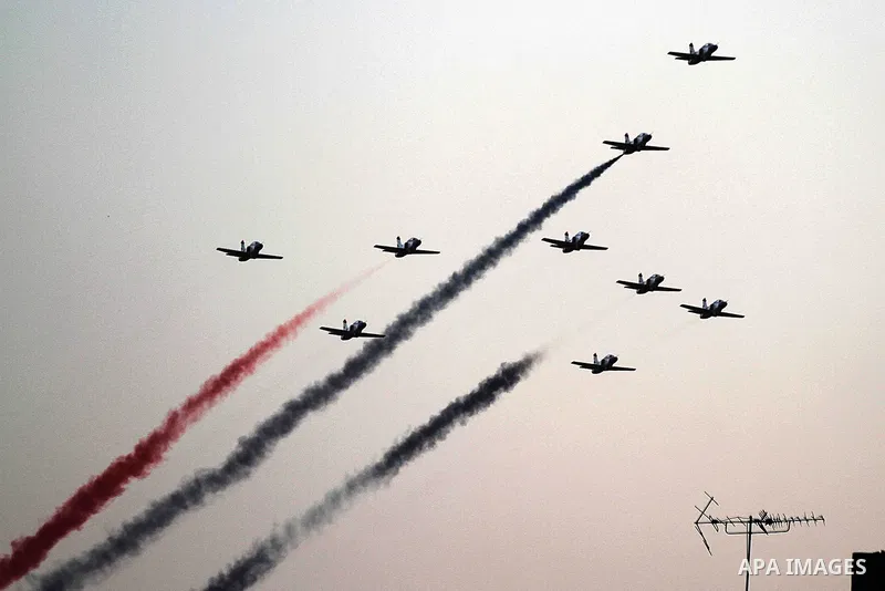 Egyptian jet fighters trail smoke in the colours of the national flag as they fly over Tahrir Square in Cairo, on July 7, 2013, as tens of thousands of people staged a show of force in Tahrir Square to back the army's ou...