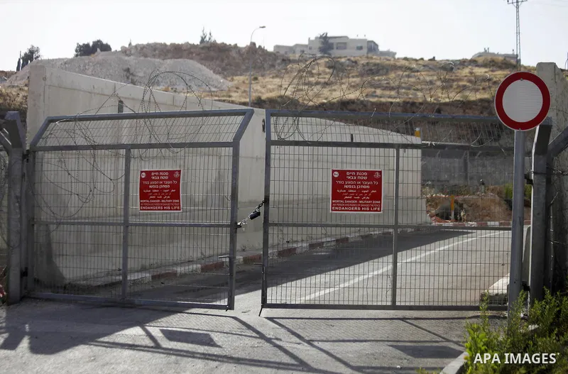 A picture shows a closed gate between Jerusalem and Anata neighborhood near Jerusalem on July 9, 2013. The Israeli Coordinator of Government Activities in the Territories (COGAT) announced in a press statement that Pales...