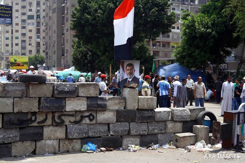 Egyptian supporters of deposed president Mohamed Morsi take part in a rally in support of the former Islamist leader outside Cairo's Rabaa al-Adawiya mosque on July 9, 2013. Egypt's interim leader vowed fresh elections b...