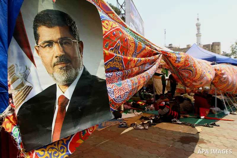Egyptian supporters of deposed president Mohamed Morsi take part in a rally in support of the former Islamist leader outside Cairo's Rabaa al-Adawiya mosque on July 9, 2013. Egypt's interim leader vowed fresh elections b...