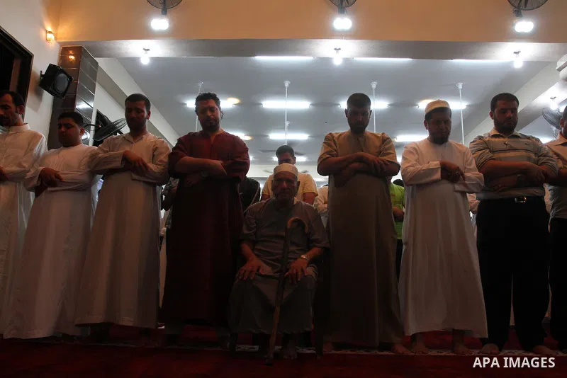 Palestinians attend the evening mass prayer session called "tarawih" led by Palestinian Prime Minister in Gaza strip Ismail Haniyeh, on the first night of the holy month of Ramadan, at the White mosque in Gaza city on Ju...