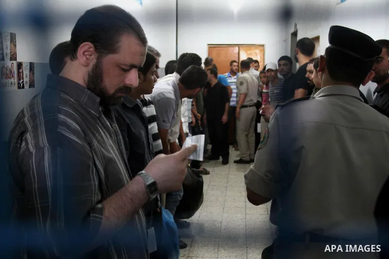 Palestinian prisoners wait to leave the prison run by the security forces in Gaza Strip, in Gaza City on July 10, 2013 Security officials in Gaza Strip said on Wednesday they released 65 criminal prisoners occasion of th...