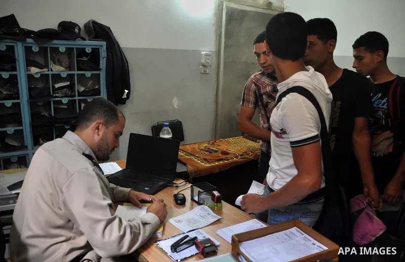 Palestinian prisoners wait to leave the prison run by the security forces in Gaza Strip, in Gaza City on July 10, 2013 Security officials in Gaza Strip said on Wednesday they released 65 criminal prisoners occasion of th...