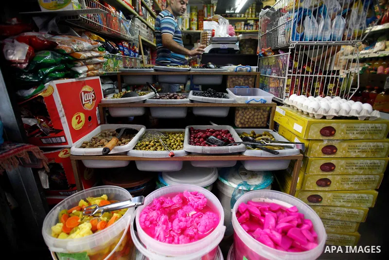 A Palestinian man sells pickles during the first day of the holy fasting month of Ramadan, in Jerusalem on July 10, 2013. Photo by Saeed Qaq