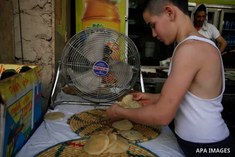 A Palestinian vendor prepares Qatayef, a traditional pancake during the first day of the holy fasting month of Ramadan, in Jerusalem on July 10, 2013. Photo by Saeed Qaq