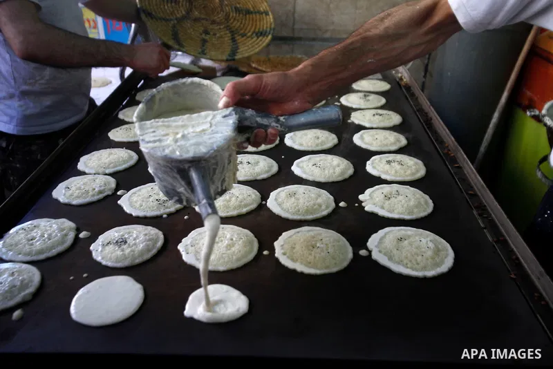 A Palestinian vendor prepares Qatayef, a traditional pancake during the first day of the holy fasting month of Ramadan, in Jerusalem on July 10, 2013. Photo by Saeed Qaq