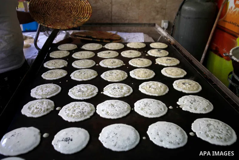 A Palestinian vendor prepares Qatayef, a traditional pancake during the first day of the holy fasting month of Ramadan, in Jerusalem on July 10, 2013. Photo by Saeed Qaq