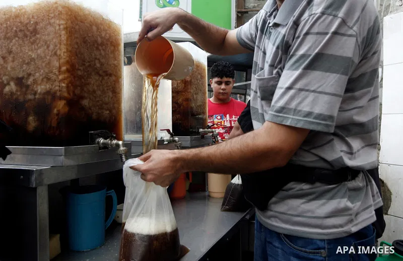 A Palestinian man sells carob juice at during the first day of the holy fasting month of Ramadan, at a street marke in Gaza city on July 10, 2013. Photo by Emad Nassar