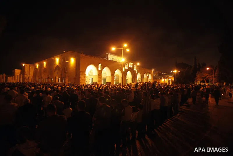 Palestinian Muslims perfom praying Taraweeh in al Aqsa mosque in the old city of Jerusalem after breaking the fast on the First day of the Moslem holy month of Ramadan on July 10, 2013. Photo by Saeed Qaq