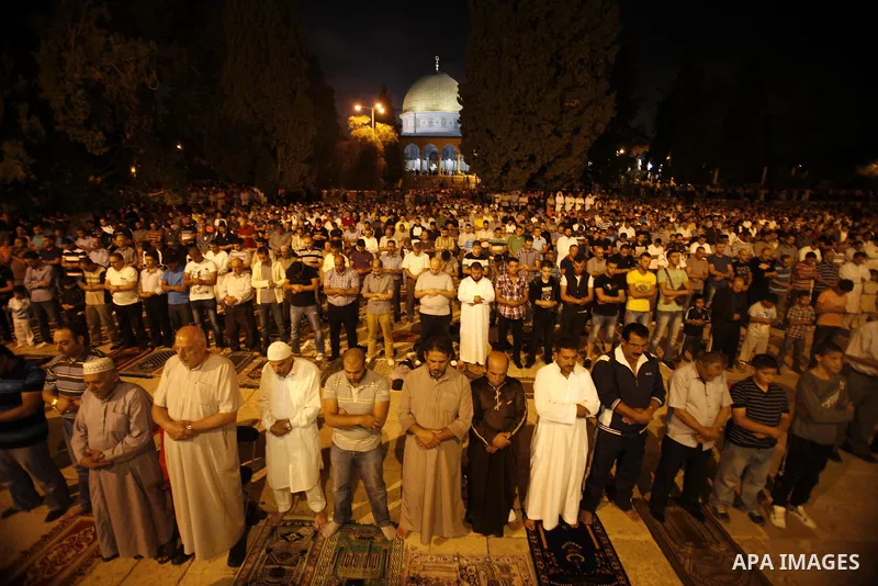 Palestinian Muslims perfom praying Taraweeh in al Aqsa mosque in the old city of Jerusalem after breaking the fast on the First day of the Moslem holy month of Ramadan on July 10, 2013. Photo by Saeed Qaq