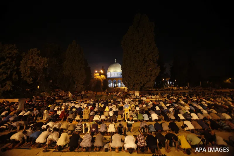 Palestinian Muslims perfom praying Taraweeh in al Aqsa mosque in the old city of Jerusalem after breaking the fast on the First day of the Moslem holy month of Ramadan on July 10, 2013. Photo by Saeed Qaq