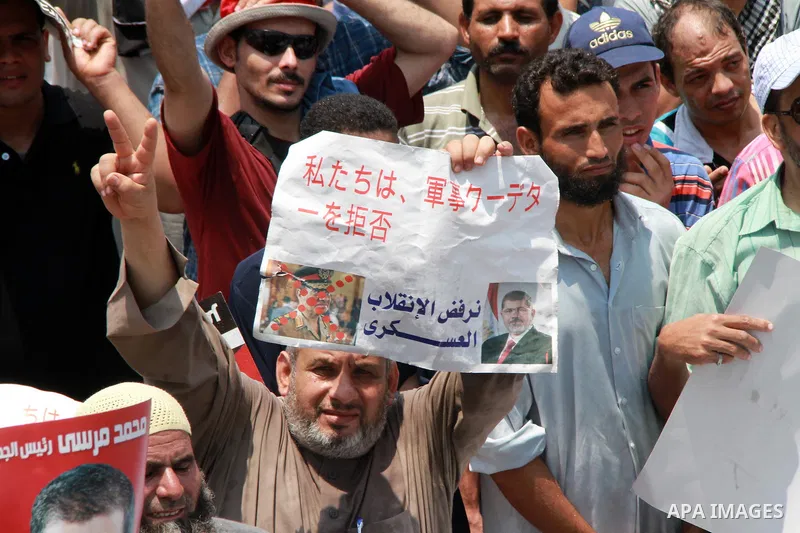 Supporters of ousted Egyptian President Mohamed Morsi take part in a protest outside Rabaa al-Adawiya mosque, after Friday prayers in Cairo, Egypt, 12 July 2013. Backers and opponents of Morsi were to hold rival rallies...