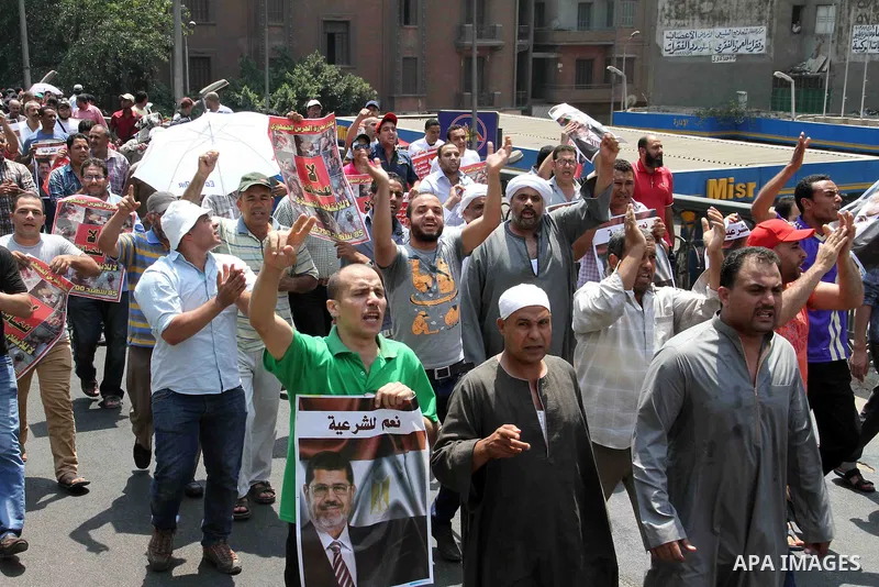 Supporters of Egypt's ousted President Mohammed Morsi shout slogans during a protest in Giza, southwest of Cairo, Egypt, Friday, July 12, 2013. Thousands of supporters of Egypt s Muslim Brotherhood group rallied in a Cai...