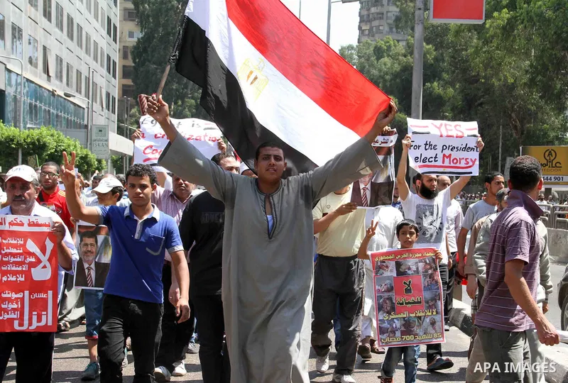 Supporters of Egypt's ousted President Mohammed Morsi shout slogans during a protest in Giza, southwest of Cairo, Egypt, Friday, July 12, 2013. Thousands of supporters of Egypt s Muslim Brotherhood group rallied in a Cai...