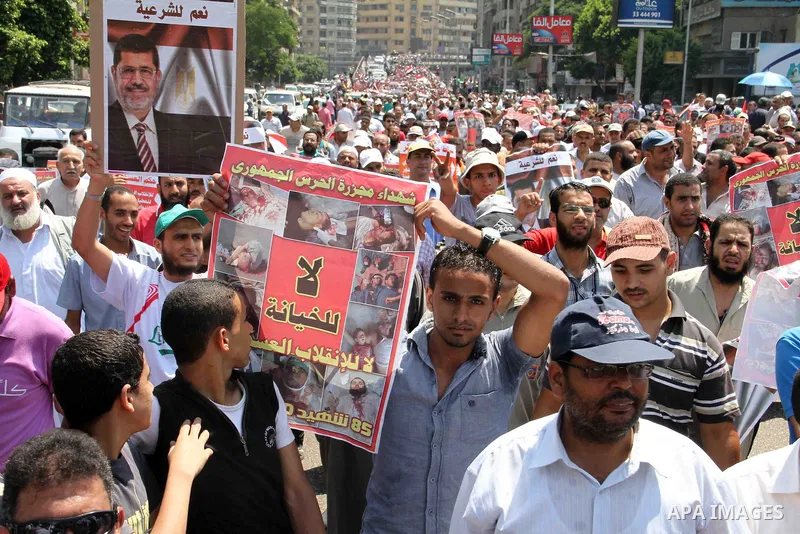 Supporters of Egypt's ousted President Mohammed Morsi shout slogans during a protest in Giza, southwest of Cairo, Egypt, Friday, July 12, 2013. Thousands of supporters of Egypt s Muslim Brotherhood group rallied in a Cai...