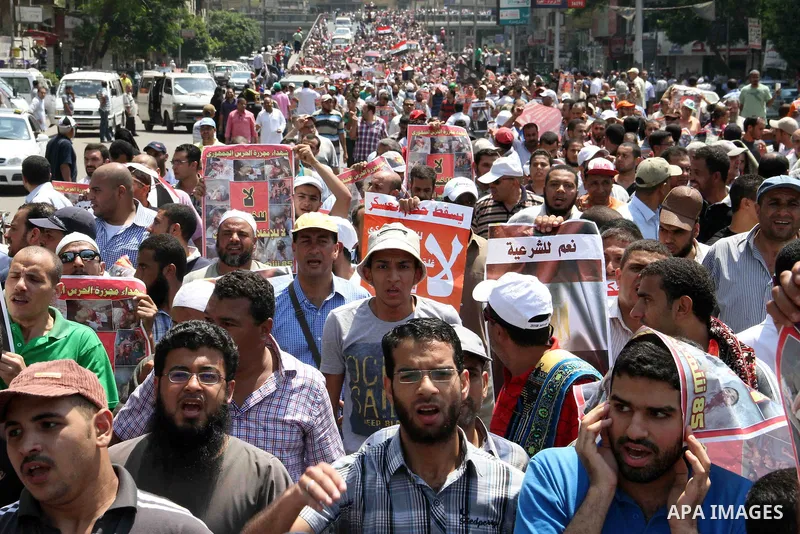 Supporters of Egypt's ousted President Mohammed Morsi shout slogans during a protest in Giza, southwest of Cairo, Egypt, Friday, July 12, 2013. Thousands of supporters of Egypt s Muslim Brotherhood group rallied in a Cai...