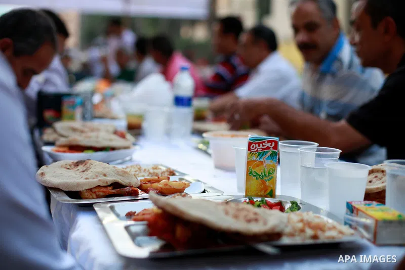 Egyptians gather for break their fast on the third day of Ramadan, in Tahrir Square, the focal point of protests against ousted President Mohammed Morsi, Friday, July 12, 2013 in Cairo. Elsewhere, tens of thousands of su...